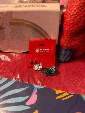 Holiday Editions silver tone Christmas earrings feature snowflake and j